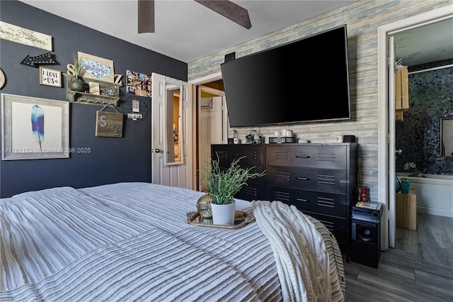 bedroom featuring a ceiling fan, wood finished floors, and a textured ceiling