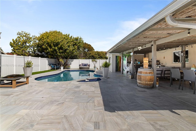 view of swimming pool with a fenced backyard, a fenced in pool, outdoor dining area, and a patio