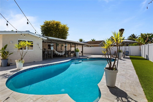 view of pool with a fenced backyard, a fenced in pool, and a patio