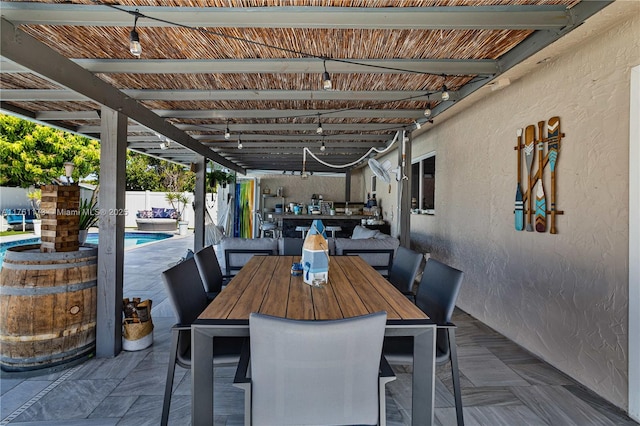 view of patio / terrace with a fenced in pool, outdoor dining space, and fence