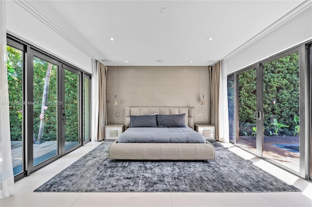 tiled bedroom featuring recessed lighting, tile walls, and access to outside