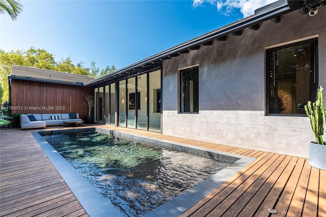 view of pool featuring a wooden deck and outdoor lounge area