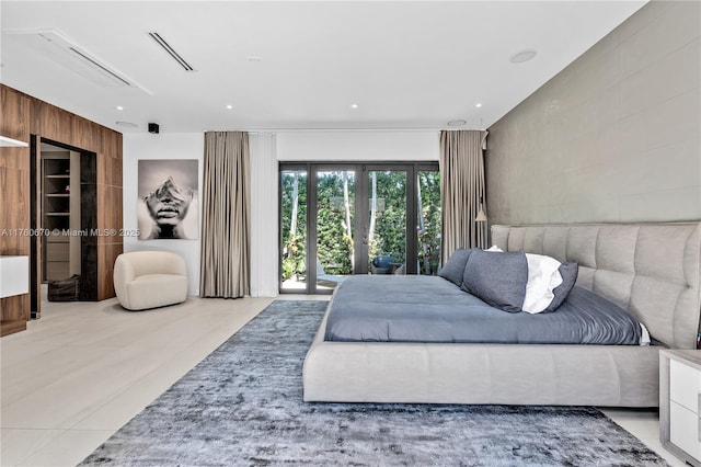 tiled bedroom featuring visible vents, recessed lighting, french doors, tile walls, and access to outside