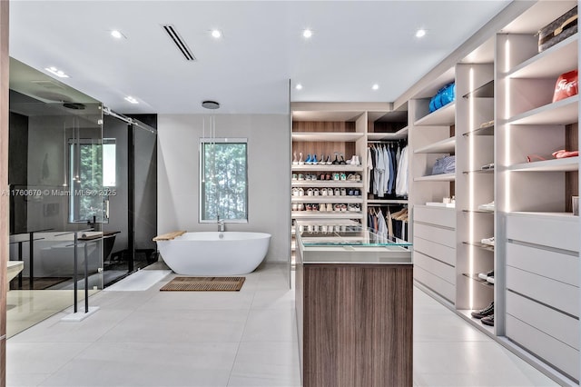 bathroom featuring visible vents, a freestanding bath, recessed lighting, a stall shower, and tile patterned floors