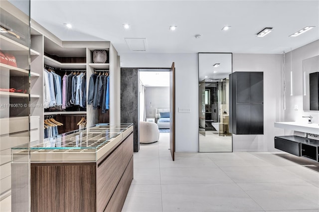 spacious closet featuring light tile patterned floors