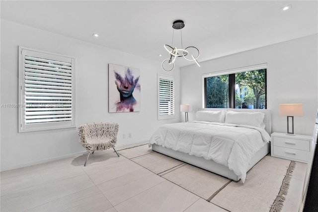 bedroom featuring recessed lighting, baseboards, and an inviting chandelier