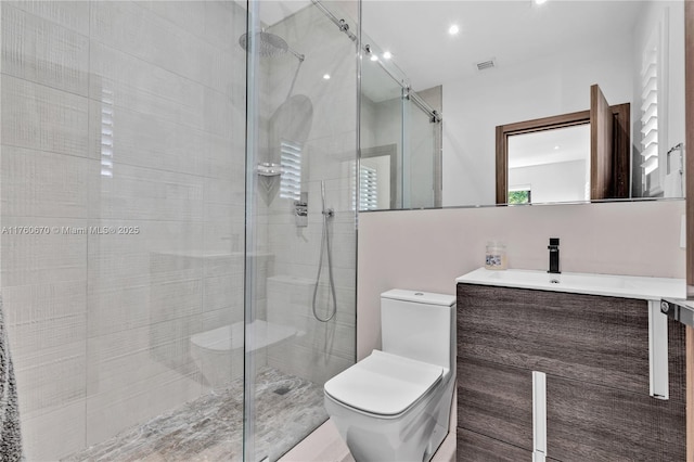 full bath featuring visible vents, a stall shower, toilet, and vanity