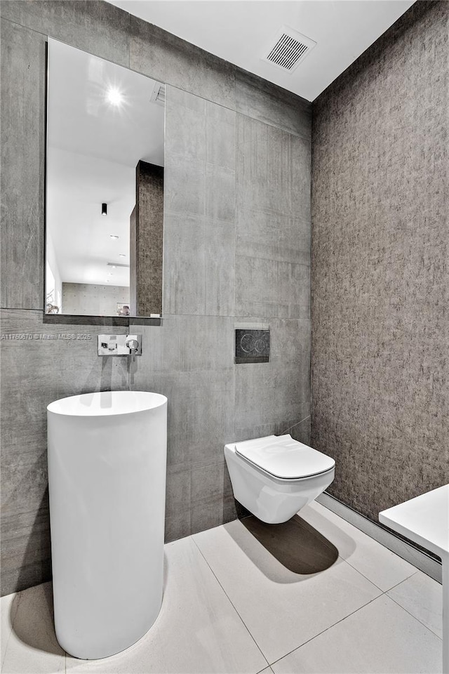 bathroom featuring tile patterned floors, visible vents, and toilet