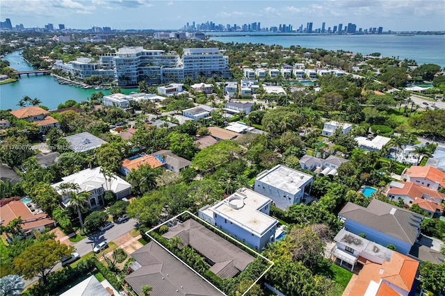 birds eye view of property with a view of city and a water view