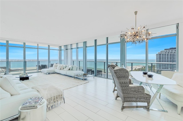 sunroom / solarium featuring a water view and a chandelier