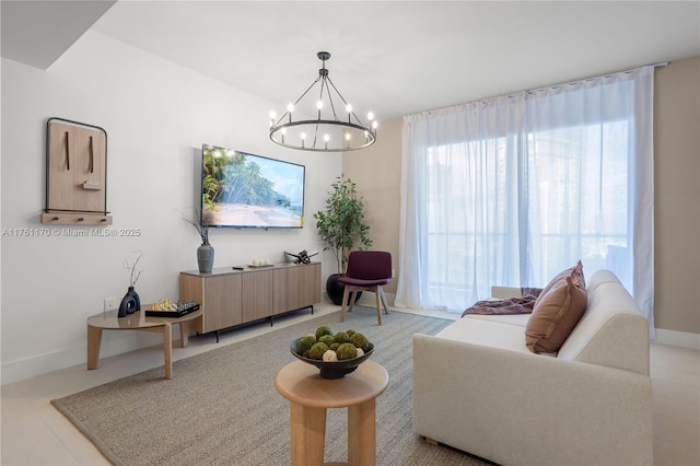 living area with baseboards and a notable chandelier