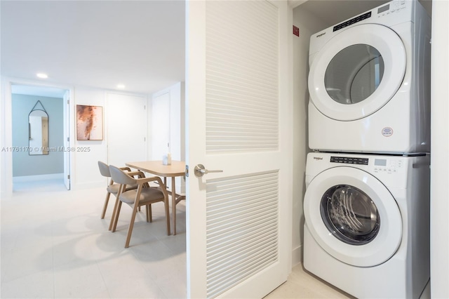 laundry area featuring recessed lighting, laundry area, and stacked washer / dryer