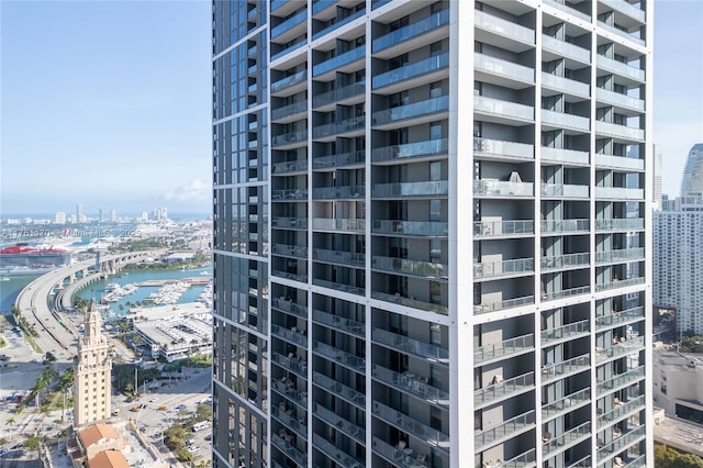 view of building exterior featuring a city view and a water view