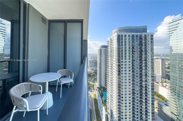 balcony featuring visible vents and a view of city