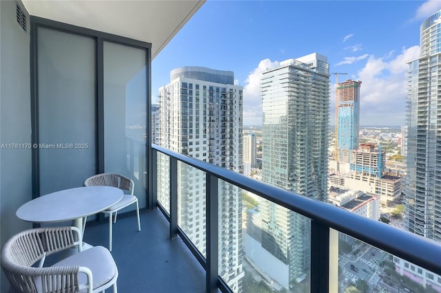 balcony with visible vents and a city view