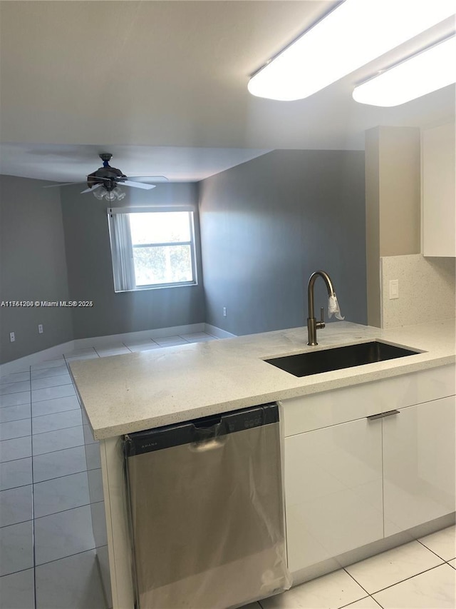 kitchen featuring dishwasher, light tile patterned floors, modern cabinets, and a sink