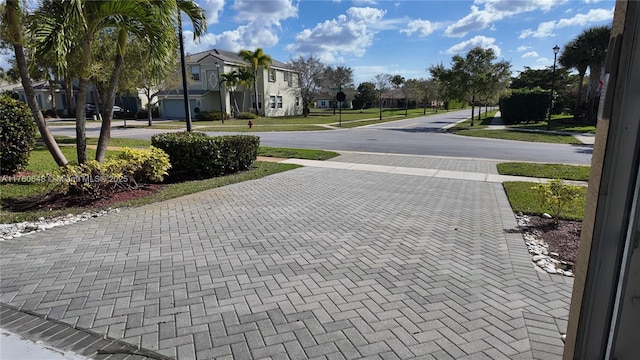 view of street featuring sidewalks, a residential view, and street lighting