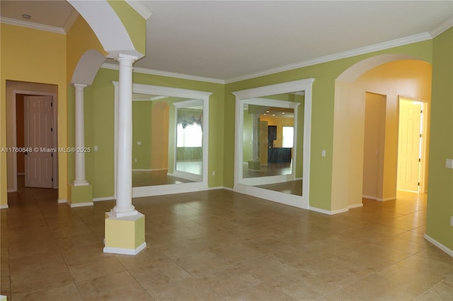 empty room with decorative columns, baseboards, ornamental molding, and light tile patterned flooring