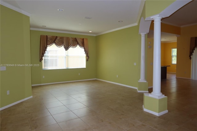 tiled empty room with decorative columns, plenty of natural light, baseboards, and crown molding