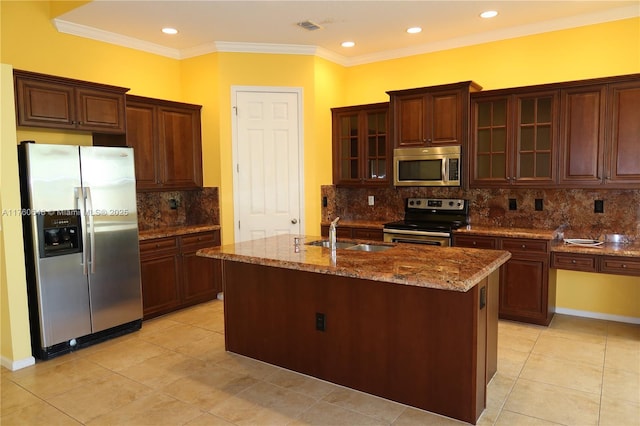 kitchen featuring dark stone countertops, visible vents, ornamental molding, a sink, and appliances with stainless steel finishes