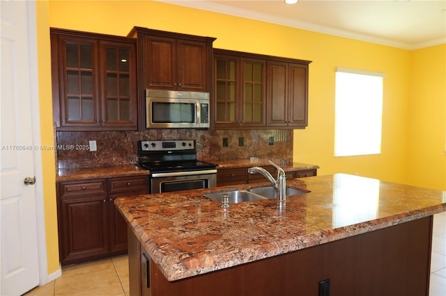 kitchen featuring a sink, tasteful backsplash, appliances with stainless steel finishes, crown molding, and stone counters