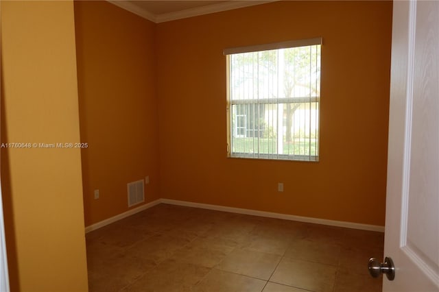 empty room with tile patterned floors, baseboards, visible vents, and a wealth of natural light