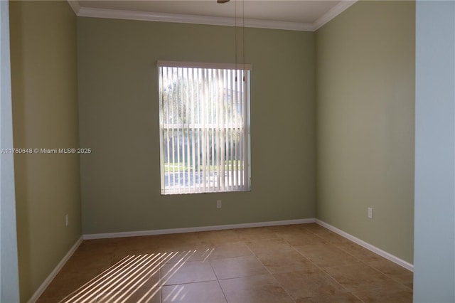 tiled spare room with crown molding, plenty of natural light, and baseboards