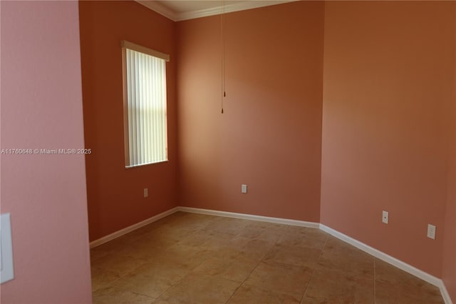 spare room featuring baseboards, ornamental molding, and light tile patterned flooring