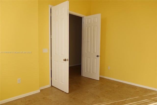 unfurnished bedroom featuring baseboards