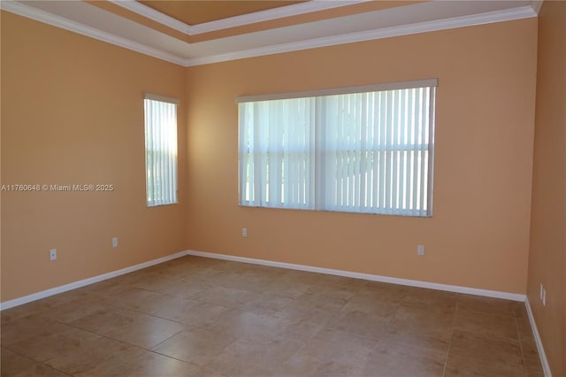 tiled empty room featuring baseboards and crown molding