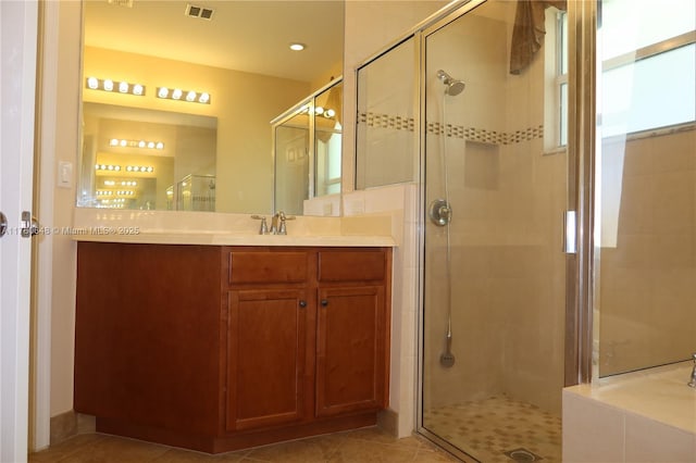 full bath featuring visible vents, a stall shower, vanity, and tile patterned flooring