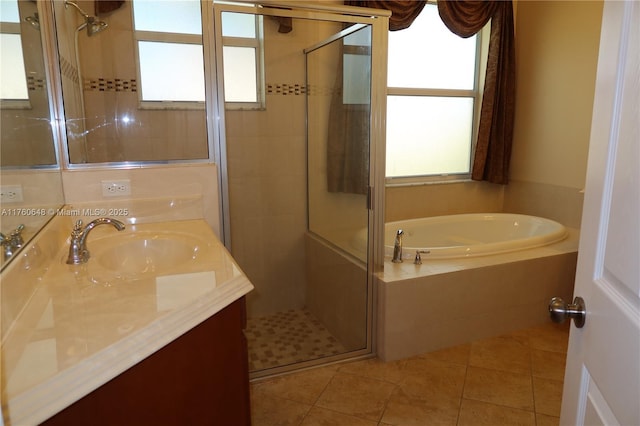 full bathroom featuring tile patterned floors, a shower stall, vanity, and a garden tub