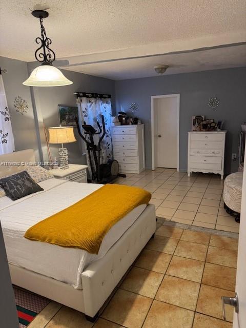 bedroom with light tile patterned floors and a textured ceiling