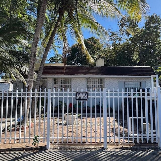 exterior space featuring a fenced front yard and a chimney