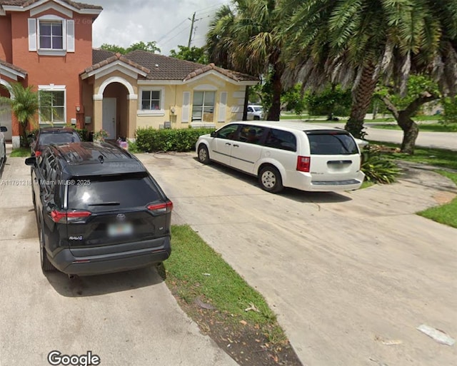 view of front of home featuring a tile roof and stucco siding