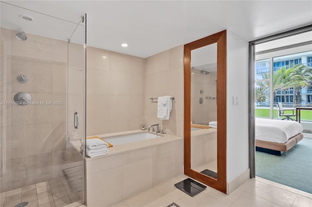 ensuite bathroom with a garden tub, tile patterned floors, a shower stall, and connected bathroom