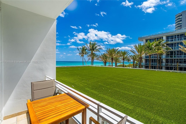 view of yard featuring a water view and a balcony