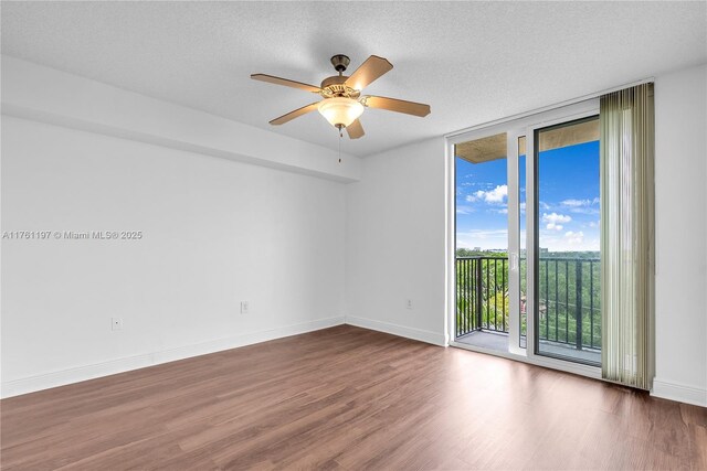 520 SE 5th Ave Unit 1507, Fort Lauderdale, FL 33301 - spare room with a wall of windows, wood finished floors, ceiling fan, and a textured ceiling