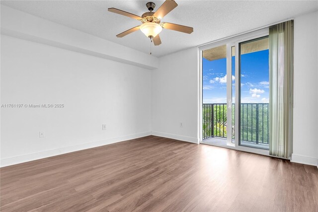 520 SE 5th Ave Unit 1507, Fort Lauderdale, FL 33301 - spare room featuring a wall of windows, wood finished floors, and ceiling fan
