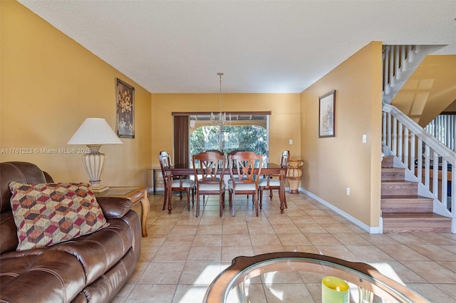 dining room with stairs, light tile patterned flooring, and baseboards