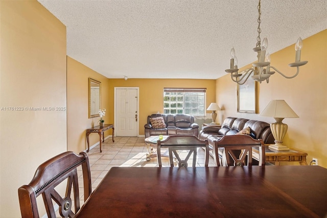 dining space with light tile patterned floors, baseboards, a textured ceiling, and an inviting chandelier