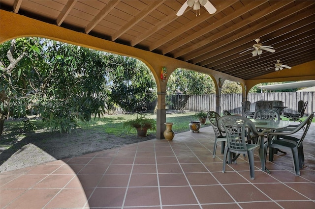 view of patio / terrace featuring outdoor dining area, ceiling fan, and fence