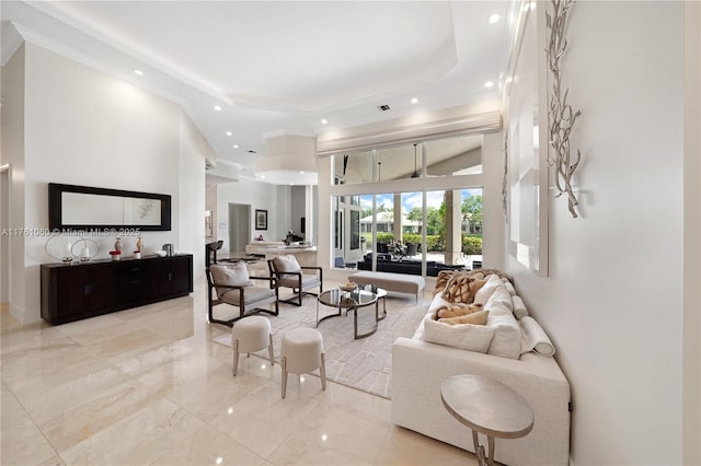 living area featuring recessed lighting, a high ceiling, and ornamental molding