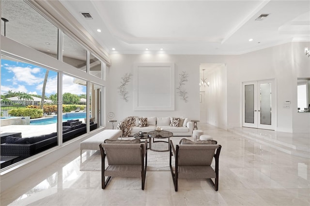 living area with a chandelier, visible vents, and marble finish floor