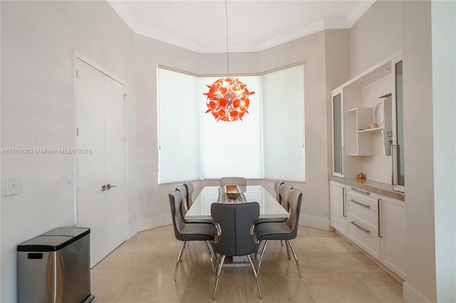 dining space featuring light tile patterned flooring, baseboards, and ornamental molding