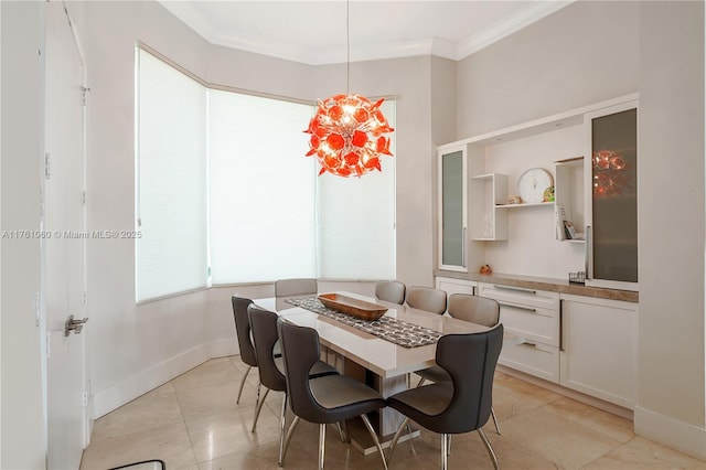 dining room with baseboards, ornamental molding, and light tile patterned flooring