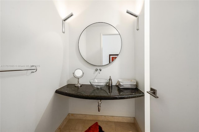 bathroom featuring a sink, baseboards, and tile patterned floors