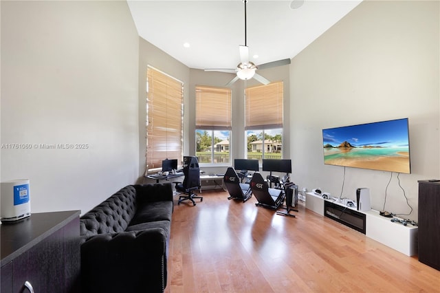 office area with a high ceiling, wood finished floors, and ceiling fan