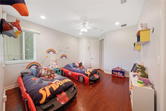 bedroom with visible vents, baseboards, and wood finished floors