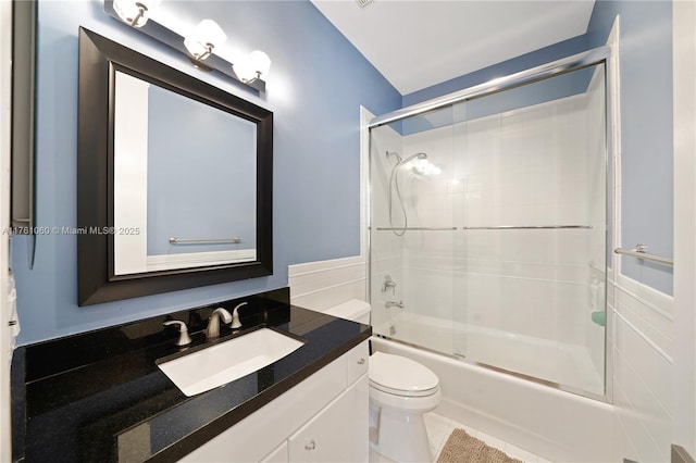 full bathroom featuring tile patterned floors, vanity, toilet, and bath / shower combo with glass door